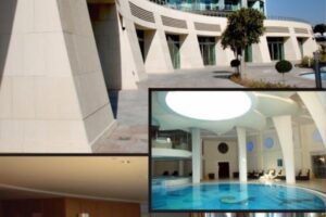 Budynek z białą fasadą, wejście i basen wewnętrzny - Metamar