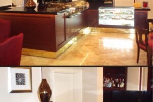 Wnętrze galerii z czerwonymi meblami, gablotami i ekranem wyświetlającym. - Metamar