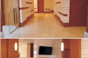 Nowoczesny korytarz z drewnianymi panelami i polyszczną podłogą.