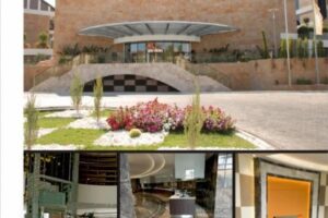 Nowoczesny budynek z zadaszonym wejściem, kwiatami i wnętrzami - Metamar