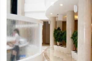 Nowoczesny korytarz z roślinami, kolumnami i oświetleniem - Metamar